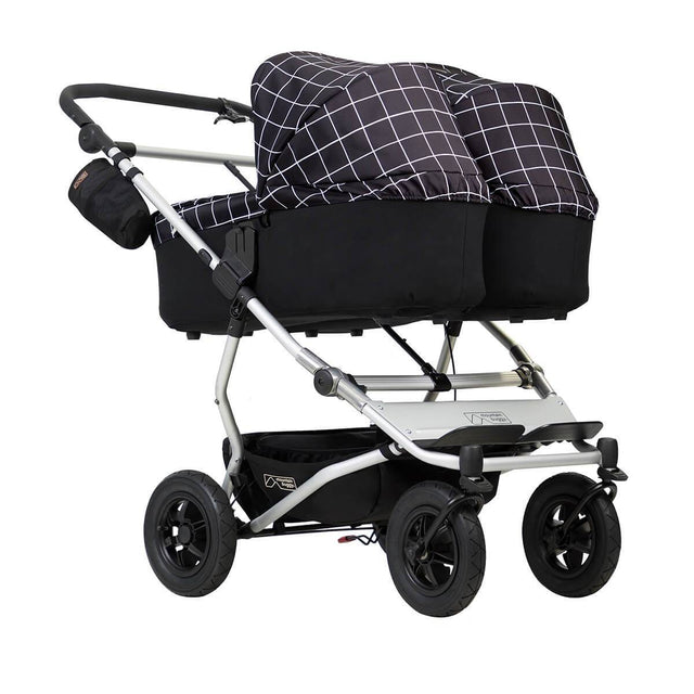 mountain buggy duet double buggy with two carrycot plus in lie flat mode 3/4 view shown in color grid_grid