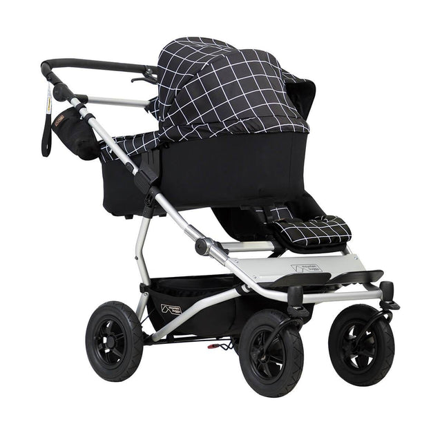 mountain buggy duet double buggy with one carrycot plus in lie flat mode 3/4 view shown in color grid_grid