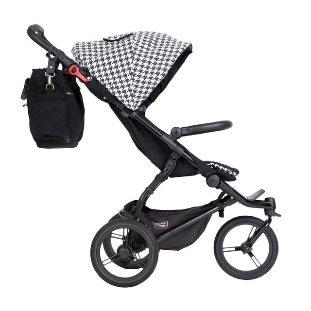 Mountain Buggy swift luxury collection stroller in pepita white and black checkered colour comes with matching pepita satchel attached to buggy side view_pepita