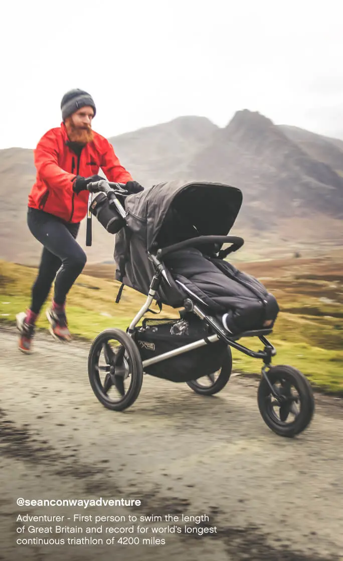Mountain Buggy terrain all terrain 3-wheel jogger with sleeping bag – dad running on a mountain trail